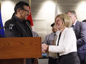 Alberta premier Rachel Notley and Chief Billy Joe Laboucan shake hands after announcing the Lubicon Lake Band agreement in Edmonton, Alta., on Wednesday October 24, 2018. The Lubicon Lake Band members have voted in favour of a settlement to their long-standing land claim.