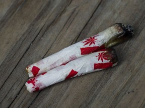 Marijuana joints rolled with Canadian-themed paper are photographed at a "Wake and Bake" legalized marijuana event in Toronto on Wednesday, October 17, 2018. The federal government is warning newcomers that stiffer impaired driving and cannabis-related penalties could lead to their removal from Canada.THE CANADIAN PRESS/Christopher Katsarov