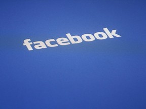 A Facebook log is displayed on the screen of an iPad, in this May 16, 2012 file photo taken in New York. Canada's election watchdog plans to hire three specialists to monitor social media for threats to the integrity of the next federal election. The move follows troublesome evidence of online Russian interference in the 2016 U.S. presidential vote. In a recruitment notice issued today, the Commissioner for Canada Elections says the specialists will collect and analyze content starting in January from social media, blogs, chatrooms, message boards, and video- and image-sharing websites.