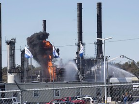 Flame and smoke erupts from the Irving Oil refinery in Saint John, N.B., on October 8, 2018. A week after a fiery explosion at Canada's largest oil refinery rocked the east side of Saint John, investigators have yet to examine the blast site because it remains a "hot zone." At least four workers received minor injuries on Oct. 8 as flames and black smoke rose into the sky above the Irving Oil refinery, which produces more than 320,000 barrels of refined energy products every day.