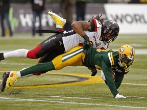 Edmonton Eskimos wide receiver Bryant Mitchell (bottom) is tackled by Ottawa Redblacks defensive back Rico Murray during CFL game action in Edmonton on Saturday October 13, 2018. (PHOTO BY LARRY WONG/POSTMEDIA)
