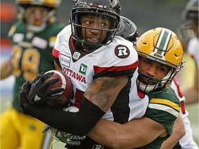 Edmonton Eskimos linebacker Corey Jones (right) tackles Ottawa RedBacks wide receiver R.J. Harris during CFL game action in Edmonton on Saturday, Oct. 13, 2018.