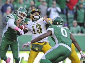 Saskatchewan Roughriders linebacker Cameron Judge strips the ball from Edmonton Eskimos quarterback Mike Reilly during second half CFL action in Regina on Monday, Oct. 8, 2018.