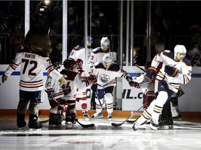 Leon Draisaitl, right, leads the Edmonton Oilers onto the ice during for an exhibition against the Cologne Sharks in Cologne, Germany, Wednesday, Oct. 3, 2018.