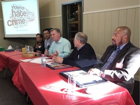 People gathered at the Twin Brooks Community League Sunday to talk about hate speech and racism. Indigenous Relations Minister Richard Feehan, centre, said citizens should be vigilant about identifying and pushing back against racism to prevent hateful incidents.