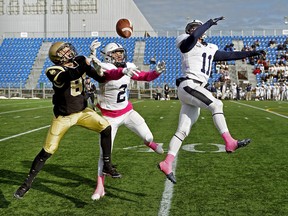 Edmonton Wildcats wide receiver Nick Hykawy (left) battles for the ball against Edmonton Wildcats defensive backs Tony Savchuk (#2) and Brady Kerr (#11) during Canadian Junior Football League Prairie Football Conference game action in Edmonton on Sunday October 14, 2018. The Huskies defeated the Wildcats by a score of 42-17. (PHOTO BY LARRY WONG/POSTMEDIA)