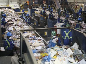 Workers sort recycling including holiday waste at Edmonton Waste Management Centre in Edmonton, Alberta on Wednesday, December 27, 2017.