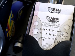 Mega Millions lottery tickets are printed out of a lottery machine at a convenience store Wednesday, Oct. 17, 2018, in Chicago. The estimated jackpot for Friday's drawing would be the second-largest lottery prize in U.S. history with a jackpot estimated to exceed $900 million.