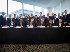 Executives from Royal Dutch Shell Plc and its international partners sign a final investment declaration to build the LNG Canada export facility in Kitimat, B.C., on Tuesday, Oct. 2, 2018.