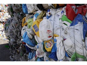 In this Thursday, Sept. 6, 2018, photo, bundled plastic goods, which were separated from paper and metal recyclable materials, are stacked and awaiting processing at EL Harvey & Sons, a waste and recycling company, in Westborough, Mass. Recycling programs across the United States are shutting down or scaling back because of a global market crisis blamed on contamination at the curbside bin.