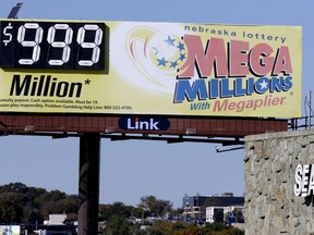 A Mega Millions billboard in Omaha, Neb., adjacent to a Sears store, shows 999 million, the maximum number it can show, ahead of the lottery draw, Friday, Oct. 19, 2018. Lottery officials increased the grand prize just hours ahead of the Friday night drawing.