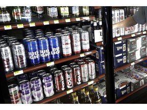 FILE - This Wednesday, April 19, 2017 file photo shows the beer cooler behind the counter in a convenience store in Sheridan, Ind. In future sweltering years with a double whammy of heat and drought, losses of barley yield can be as much as 17 percent, computer simulations show. And that means "beer prices would, on average, double," even adjusting for inflation, said a study published in the journal Nature Plants on Wednesday, Oct. 17, 2018.