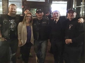 UCP Edmonton-West Henday nomination candidate Nicole Williams poses with members of the Soldiers of Odin during a UCP Edmonton-West Henday Constituency Association pub night at Brown’s Social House on Friday, Oct. 5, 2018.