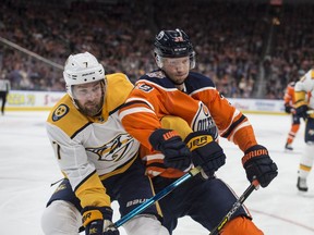 Alex Chiasson of the Edmonton Oilers, goes into the corner with Yannick Weber of the Nashville Predators at Rogers Place in Edmonton on October 20, 2018.  Shaughn Butts / Postmedia