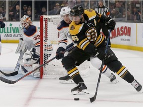 Boston Bruins center David Krejci (46) looks to shoot on Edmonton Oilers goaltender Cam Talbot (33) as forward Ryan Strome defends during the second period of an NHL hockey game Thursday, Oct. 11, 2018, in Boston.