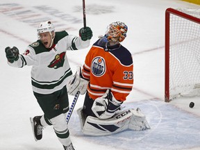 Minnesota Wild centre Charlie Coyle (left) celebrates after team mate Eric Staal (not in photo) scored on Edmonton Oilers goalie Cam Talbot (right) during NHL hockey game action in Edmonton on Tuesday October 30, 2018. (PHOTO BY LARRY WONG/POSTMEDIA)