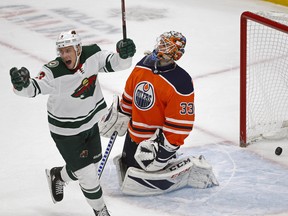 Minnesota Wild centre Charlie Coyle (left) celebrates after team mate Eric Staal (not in photo) scored on Edmonton Oilers goalie Cam Talbot (right) during second period NHL hockey game action in Edmonton on Tuesday October 30, 2018. Minnesota defeated Edmonton by a score of 4-3. (PHOTO BY LARRY WONG/POSTMEDIA)
