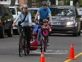 Julie Kusiek and her family ride along a temporary bike route on 83 Avenue in a 2014 photo.