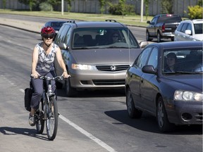 A cyclist rides westbound in a bike lane along 95 Avenue at 178 Street next cars in Edmonton, Alta., on Tuesday July 7, 2015. Edmonton city council members voted to remove the lane along 95 Avenue in 2015.