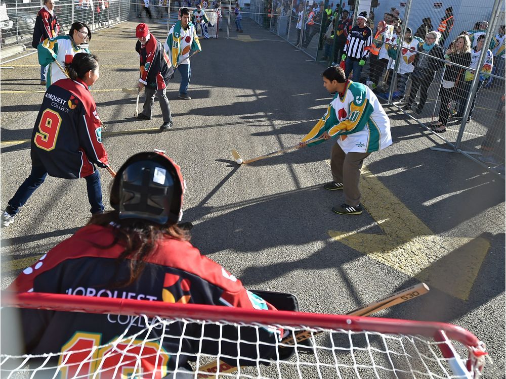 Learning Canada's game New residents pick up hockey sticks for the
