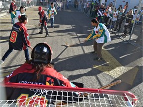 Teams Deaf Tigers, in white, and Red and White compete for the NorQuest Cup and Spirit Awards at the annual road hockey tournament which involves eight 15-minute games outside NorQuest College in Edmonton on Friday, Oct. 19, 2018.