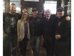 UCP Edmonton-West Henday nomination candidate Nicole Williams poses with members of the Soldiers of Odin during a UCP Edmonton-West Henday Constituency Association pub night at Brown's Social House on Oct. 5, 2018.