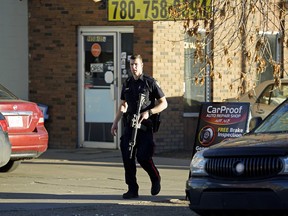 Police investigate a shooting at CarProof Auto Repair at 9650 105A Ave. in downtown Edmonton on Tuesday, Oct. 23, 2018. LARRY WONG / POSTMEDIA