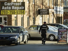 Police investigate a shooting at a downtown car repair shop near 97 Street and 105A Avenue on Tuesday, Oct. 23, 2018. The shooting victim, a 36-year-old male, was transported to hospital by ambulance, where he died.