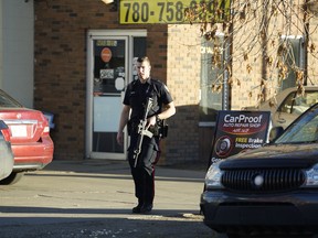 Police investigate a shooting at CarProof Auto Repair at 9650 105A Ave. in downtown Edmonton on Tuesday, Oct. 23, 2018.
