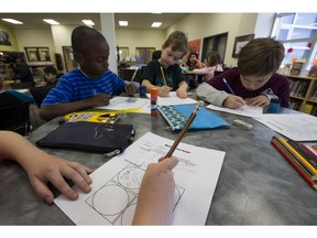 Anton Shepherd works on his mission patch along with classmates, Joseph Omoko, left, Brett Pascuzzo and  Holden Retnz at Michael Strembitsky School on Tuesday, Oct. 30, 2018 in Edmonton. One student's artwork from Edmonton Public Schools will be selected to be worn by astronauts on the International Space Station in spring 2019.