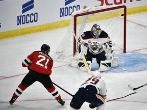 New Jersey Devils' Kyle Palmieri, left, scores, during the season-opening NHL Global Series hockey match between Edmonton Oilers and New Jersey Devils at Scandinavium in Gothenburg, Sweden, Saturday, Oct. 6, 2018,