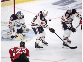 Edmonton Oilers defenceman Matt Benning blocks a shot in front of goalie Cam Talbot during the season-opening NHL Global Series hockey match between Edmonton Oilers and New Jersey Devils at Scandinavium in Gothenburg, Sweden, Saturday, Oct. 6, 2018.