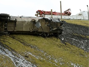 A semi tanker trailer detached from the truck and flipped over a guard rail on the Anthony Henday Drive overpass to Calgary Trail on Monday afternoon, October 1, 2018. The truck was carrying 37,500 litres of hot liquid asphalt, which spilled down the embankment and into a provincial storm sewer system. The driver was not injured.