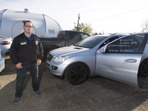 Edmonton Police Service auto theft unit Det. Mark Kassian with several of the recovered vehicles from a VIN cloning operation on Thursday, Oct. 4, 2018 in Edmonton.