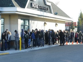 Customers line up outside Nova Cannabis in north Edmonton, waiting for the store to open on the first day of legalized cannabis in Canada on Wednesday, Oct. 17, 2018.