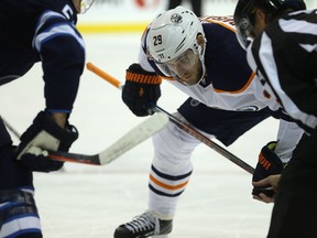 Edmonton Oilers centre Leon Draisaitl lines up in the face-off circle against Winnipeg Jets centre Mark Scheifele in Winnipeg on Tues., Oct. 16, 2018.