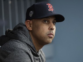 Boston Red Sox manager Alex Cora waits for the start of Game 5 of the World Series baseball game between the Boston Red Sox and Los Angeles Dodgers on Sunday, Oct. 28, 2018, in Los Angeles.