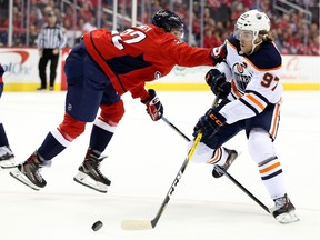 Washington Capitals' Madison Bowey checks Edmonton Oiler Connor McDavid during the first period at Capital One Arena on Monday, Nov. 5, 2018.