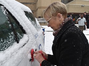 Lynda McCullough lost her daughter to a drunk driver, tying on a ribbon to mark the start of MADD Edmonton & Area Chapter's Project Red Ribbon campaign to promote sober driving throughout the upcoming holiday season in Edmonton, November 2, 2018. They are asking residents to tie a MADD Canada red ribbon to their vehicles, key chains, purses, briefcases and backpacks. It symbolizes a person's commitment to drive safe, and reminds other motorists to always drive sober as well. Ed Kaiser/Postmedia