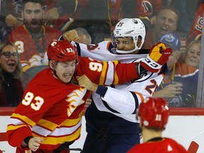 Edmonton Oilers Darnell Nurse, right and Calgary Flames Sam Bennett in NHL hockey action at the Scotiabank Saddledome in Calgary, Alta. on Saturday November 17, 2018. Leah Hennel/Postmedia