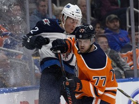 The Edmonton Oilers Oscar Klefbom (77) checks the Winnipeg Jets' Mason Appleton (82) during second period pre-season NHL action at Rogers Place, in Edmonton Thursday Sept. 20, 2018. David Bloom / Postmedia