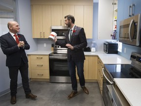 Edmonton Centre MP Randy Boissonnault, left, and Mayor Don Iveson tour the Bissell Centre kitchen in Edmonton on Friday, Nov. 2, 2018. On Friday Boissonnault announced $885,000 in funding to the Canadian Alliance to End Homelessness.