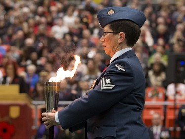 The Peach Torch is carried into position during a Remembrance Day Service at the University of Alberta's Van Vliet Centre, in Edmonton Sunday Nov. 11, 2018.