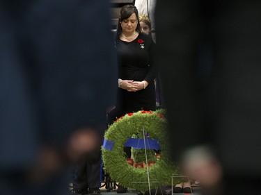 Memorial Cross recipient Lisa Schamehorn - Eades is framed by soldiers during the Remembrance Day Service at the University of Alberta's Van Vliet Centre, in Edmonton Sunday Nov. 11, 2018. Her husband, Sgt. Shawn Eades, died Aug. 20, 2008, during his third tour in Afghanistan.