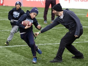 Edmontonians play flag football during the Grey Cup street festival in downtown Edmonton, Thursday November 22, 2018.