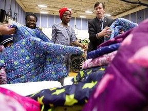 Children pick out new winter coats during the Knights of Columbus Coats For Kids event at St. Teresa of Calcutta School on Saturday, Nov. 24.