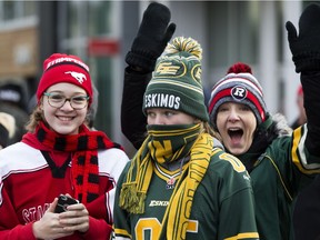 Calgary, Edmonton, and Ottawa football fans watch the Grey Cup Parade.