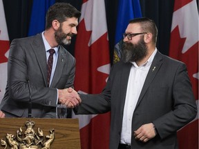 Edmonton Mayor Don Iveson shakes hands with Municipal Affairs Minister Shaye Anderson (right) during a press conference to announce a new funding agreement on Thursday, Nov. 29, 2018.