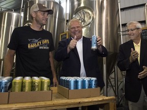Ontario Premier Doug Ford, centre, at Barley Days brewery in Picton, Ont., on Aug. 7, 2018. The Alberta government is launching a trade challenge against Ontario over what it says are discriminatory practices.