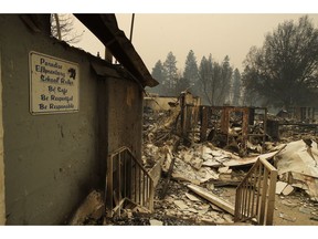 A sign hangs on a wall at the Paradise Elementary School destroyed by the Camp Fire, Tuesday, Nov. 13, 2018, in Paradise, Calif.